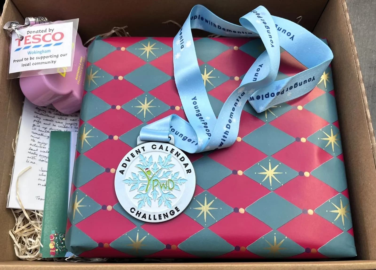 Advent Calendar Challenge medal and prize box for one of our top fundraisers in 2025